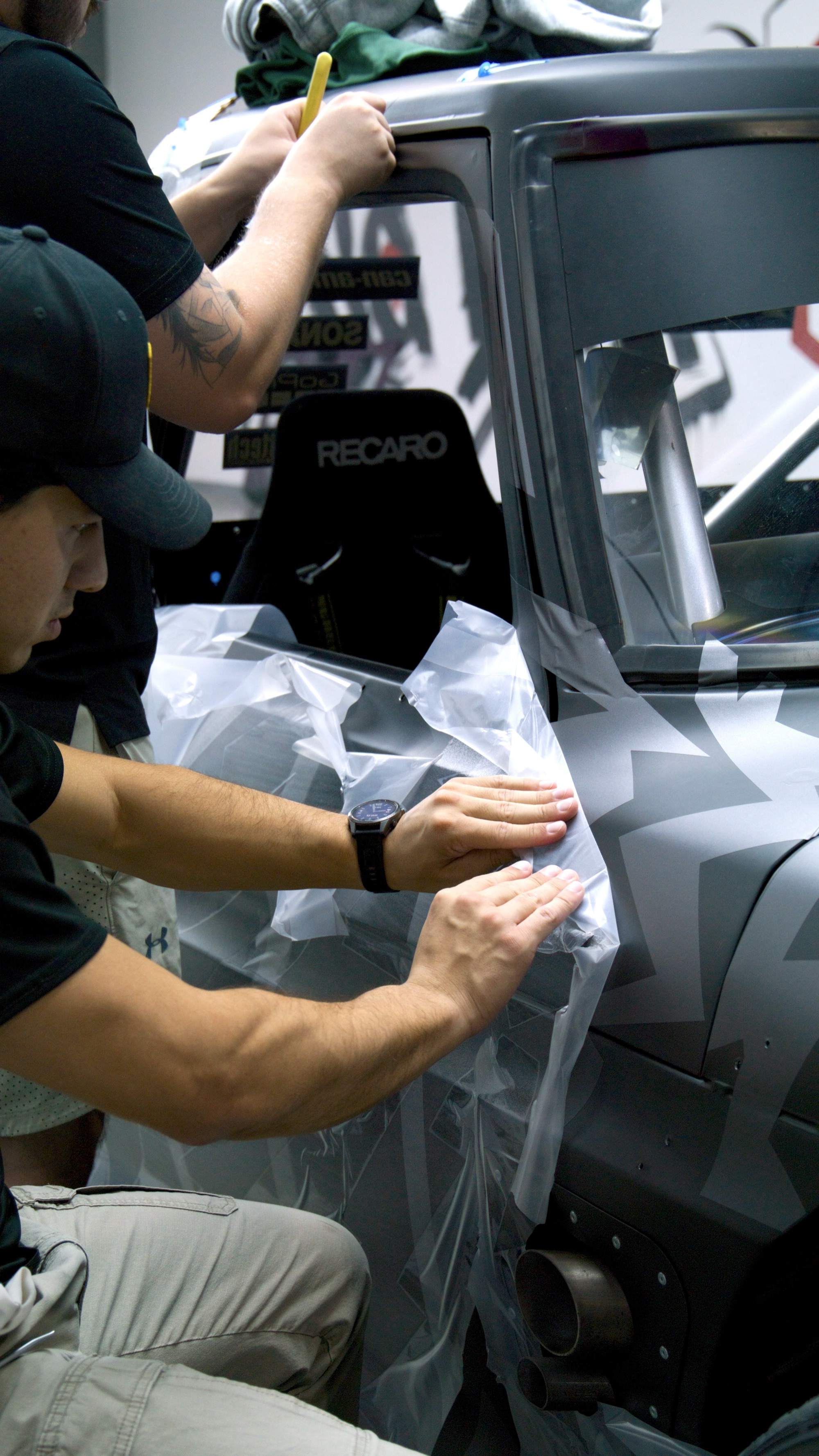 Camouflage livery vinyl installation at Red Box Restoration